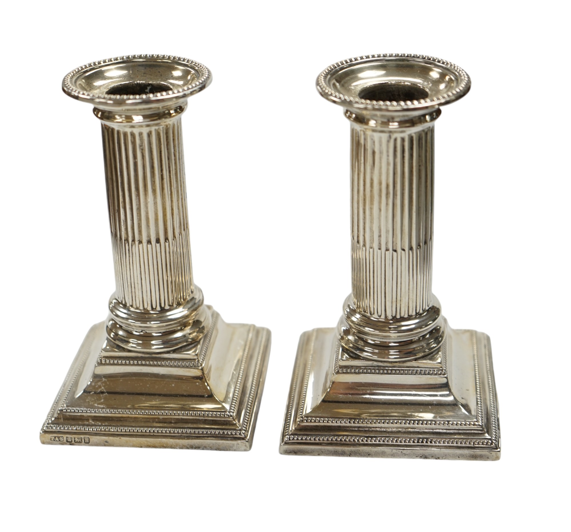 A pair of Edwardian silver dwarf candlesticks, Thomas A. Scott, Sheffield, 1905, height 12.5cm, weighted. Condition - fair